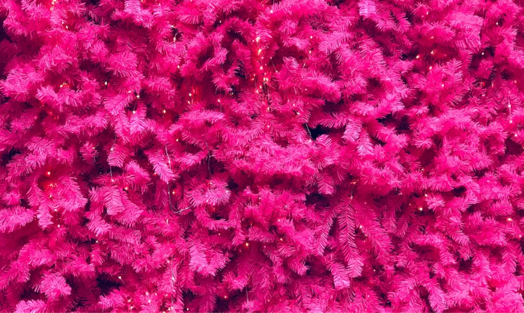 Artificial pink leafed plants illustrating pink color psychology associated with romance, softness, and comfort in modern décor.