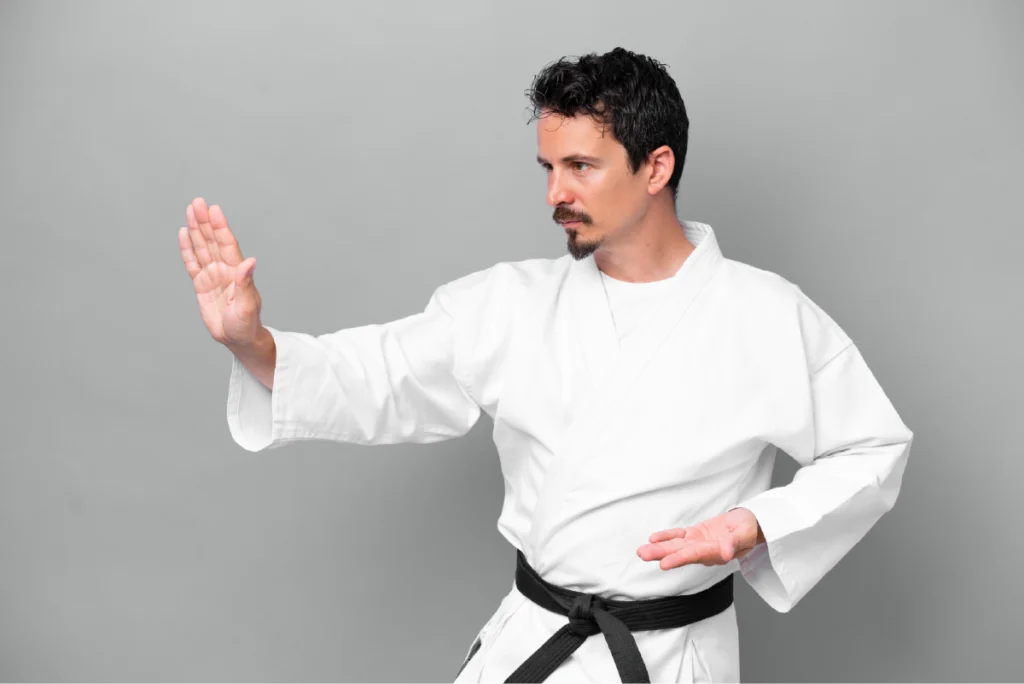 Martial artist wearing a black belt during practice, illustrating black color psychology through discipline and mastery.