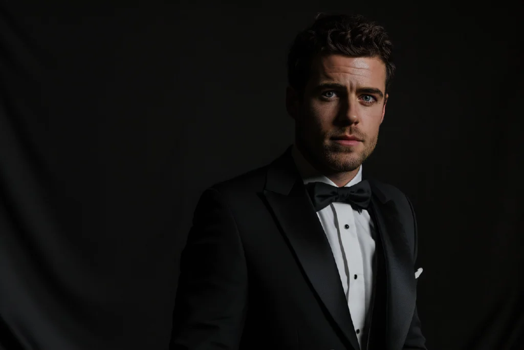 Person wearing black formal attire against a dark background, representing emotional restraint and confidence of black color personality.