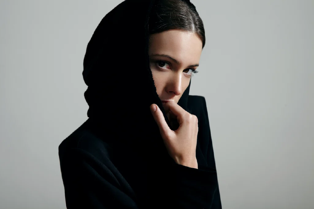 Muslim woman wearing a black outer garment and head covering, illustrating black color psychology through cultural symbolism of modesty, restraint, and spiritual focus.