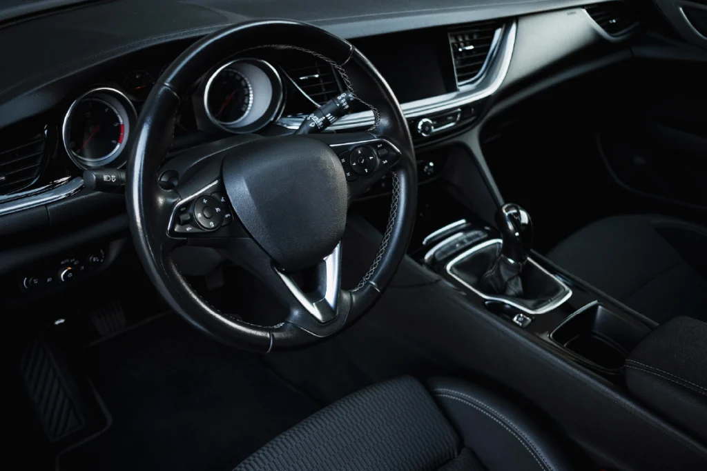 Modern vehicle interior featuring black surfaces, illustrating black color psychology associated with modernity and efficiency.